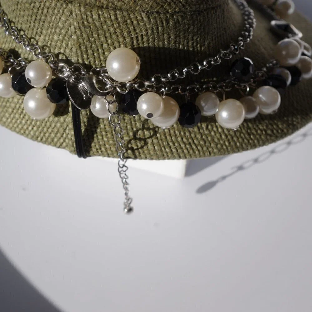 Women`s silver tone faux pearl black necklace.